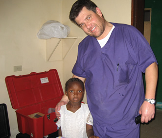 Dr. Blum providing dental care to a young boy.